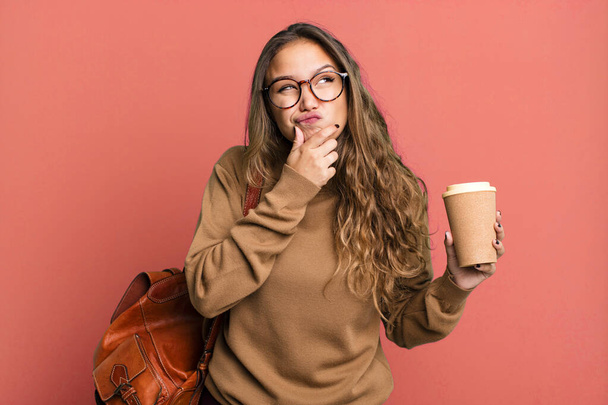 hispanic pretty woman thinking, feeling doubtful and confused. take away coffee concept - Valokuva, kuva