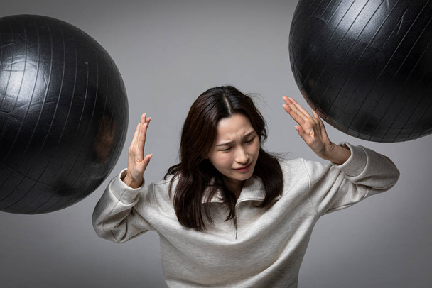 stressed, depressed Korean business woman in pink suit, exhausted - Fotó, kép