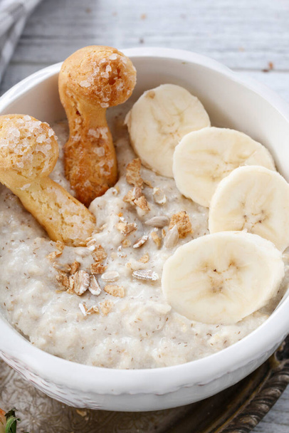 Porridge with bananas in a bowl. Breakfast time - Фото, зображення