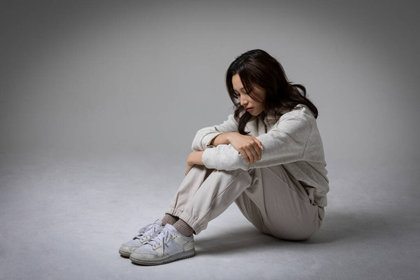 stressed, depressed Korean business woman in pink suit, frustrated - Fotó, kép