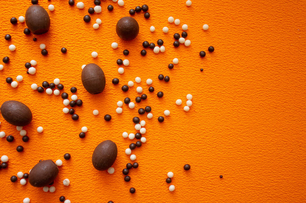 chocolate balls on an orange background - Zdjęcie, obraz