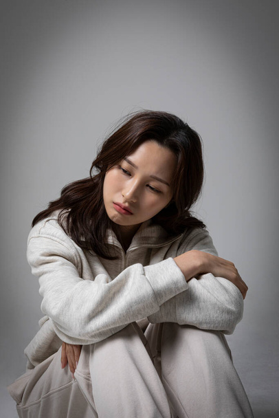 stressed, depressed Korean business woman in pink suit, frustrated - Zdjęcie, obraz