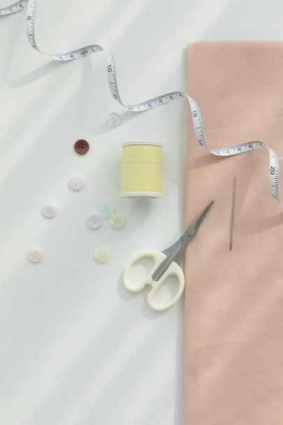 aesthetic photo of handmade, crafting hobbies, tape measure of fabric and thread buttons - Foto, Bild
