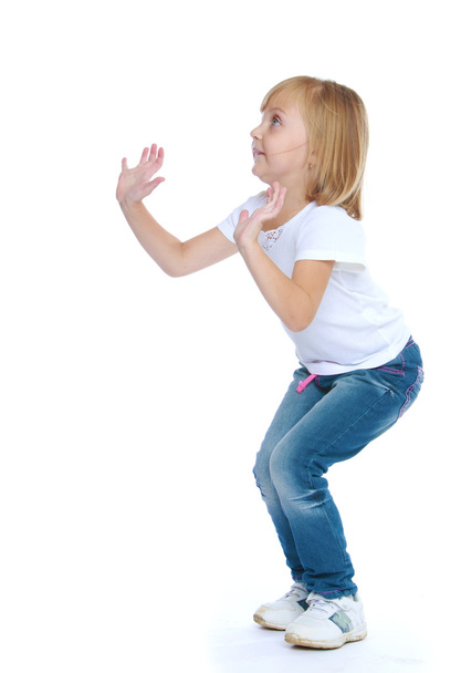 Little girl jumping hands up. - Foto, Imagen