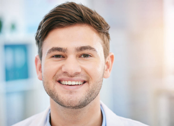 Smile, doctor face and portrait of man in hospital with for wellness, medicine and medical care. Healthcare, headshot and closeup of happy health worker in clinic for consulting, trust and mockup. - Foto, imagen