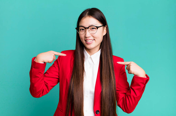 young adult pretty asian businesswoman wearing red blazer and glasses - Zdjęcie, obraz