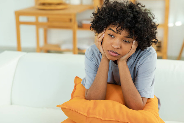 African american sad thoughtful girl at home. Young african woman feels depressed offended lonely upset suffers from abuse harassment heartbreak. Grieving violence victim has psychological problem - Φωτογραφία, εικόνα