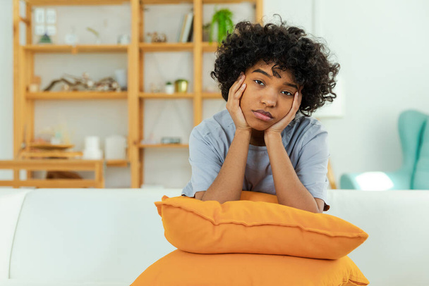African american sad thoughtful girl at home. Young african woman feels depressed offended lonely upset suffers from abuse harassment heartbreak. Grieving violence victim has psychological problem - Foto, immagini