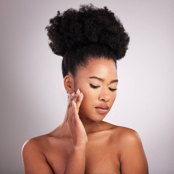Skincare, beauty and black woman with hand on face, white background and cosmetics. Health, dermatology and natural makeup and African model in studio space for healthy skin care and wellness - Foto, immagini