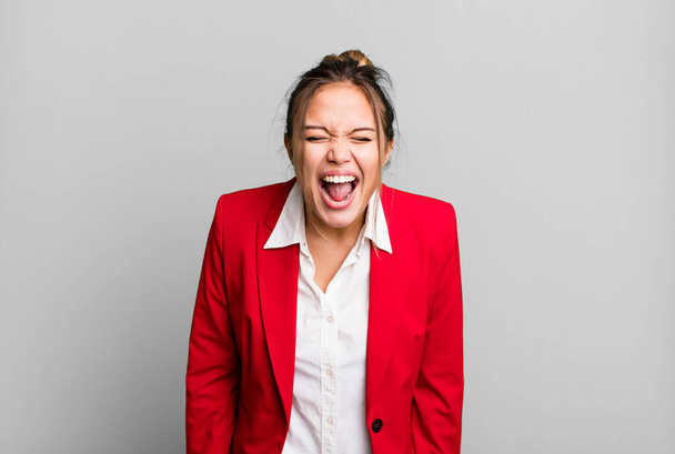 hispanic pretty woman shouting aggressively, looking very angry. business concept - Photo, Image