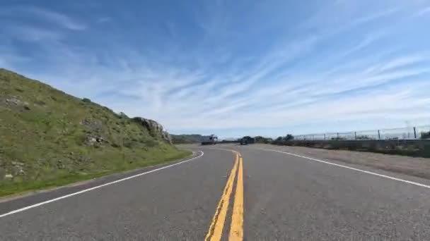 Велосипедист крутит педали на ветреном шоссе 1 на вершине скал на Калифорнийском побережье. Высококачественные 4k кадры - Кадры, видео