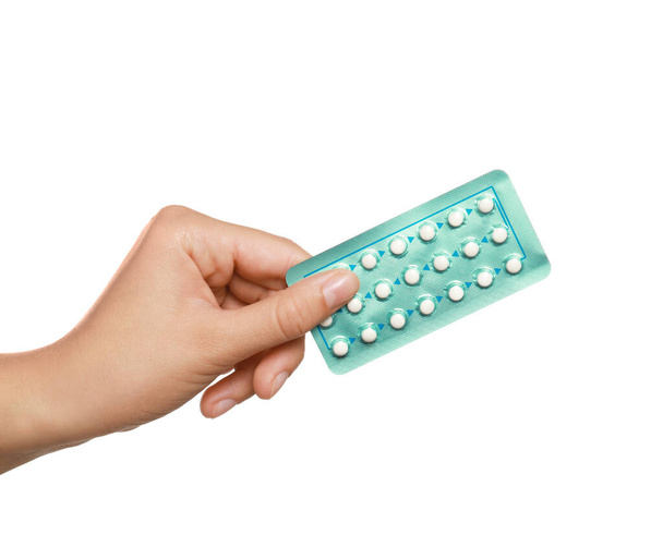 Woman holding blister of oral contraception pills on white background, closeup - Фото, изображение