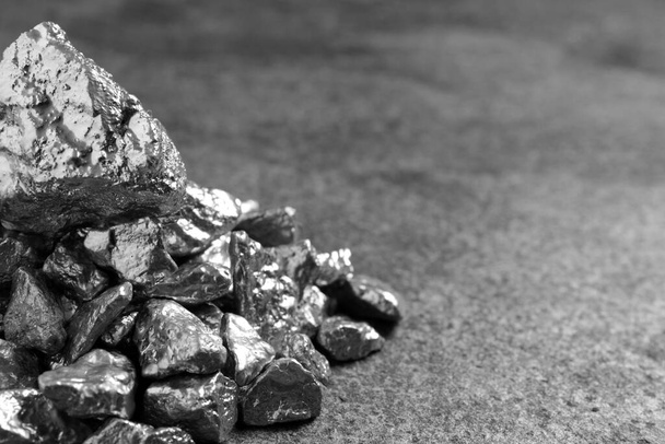 Pile of silver nuggets on grey textured table, closeup. Space for text - Fotoğraf, Görsel