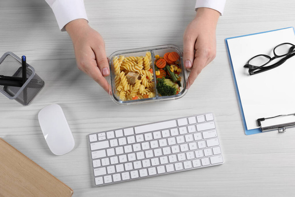 Office employee having business lunch at workplace, top view - Photo, image