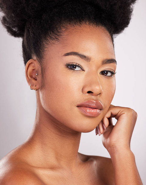 Skincare, beauty and portrait black woman with serious face, white background and cosmetics product. Health, dermatology and natural makeup, African model in studio for healthy skin care and wellness. - Photo, Image