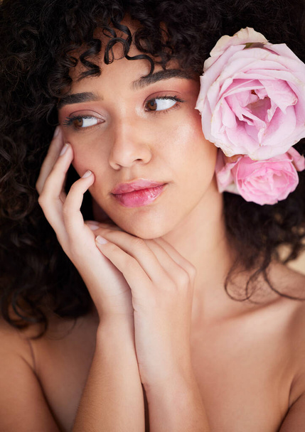 Beauty, flowers and face of woman with makeup, cosmetics and hair care for wellness, glamour and glow in studio. Salon aesthetic, luxury spa and girl model for natural, skincare and facial treatment. - 写真・画像