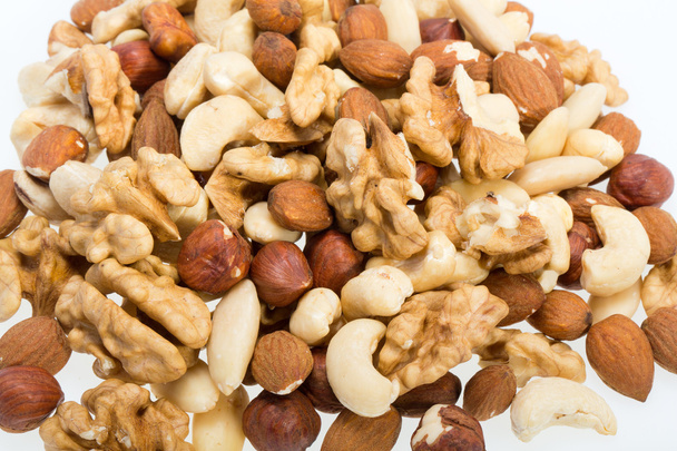 Background of mixed nuts -  hazelnuts, walnuts, cashews,  pine nuts - Photo, Image