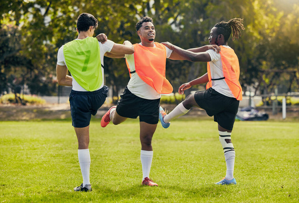 Sports men, training and outdoor rugby on a grass field with a team stretching legs as warm up. Athlete group together for fitness, exercise and workout for diversity sport with coach and teamwork. - Photo, Image