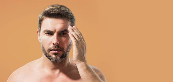 Cosmetics, body care and spa treatment. Portrait of masculinity charming shirtless man isolated over white background. Close-up portrait of attractive guy. Banner for header, copy space - Foto, Bild