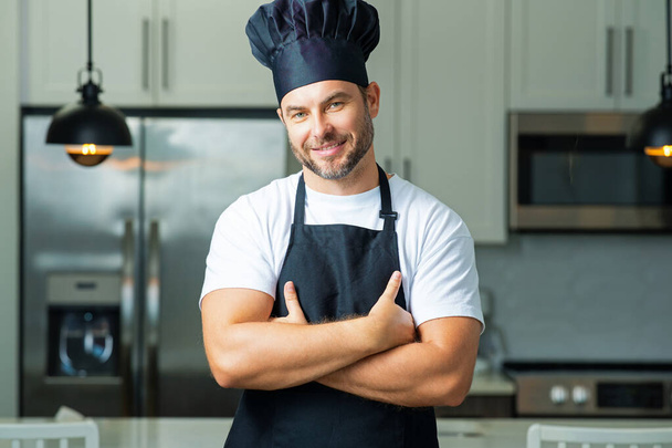 Man chef cooker baker. Millennial male chef in chefs uniform. Chef man cooking on kitchen. Chef cook in hat and apron - Fotografie, Obrázek