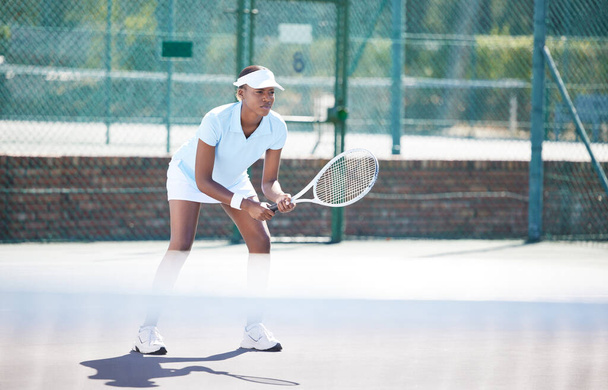 Tennis, outdoor match and black woman wait for sports ball serve with a racket on exercise court. Sport game, workout competition and young female ready for wellness and health challenge in summer. - Foto, Imagem