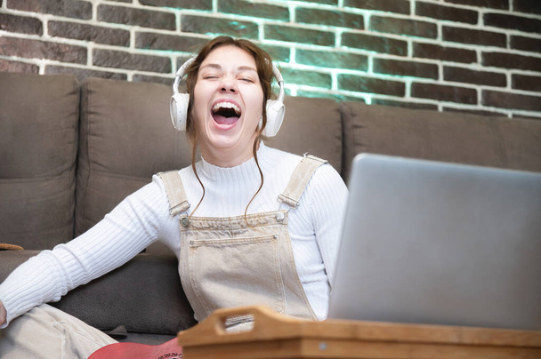 Singing song with emotion.Practicing vocal abilities. Improving range.Cheerful woman listening to music with large headphones and singing.Relaxing with music,happy woman singing.Positive mood. - Foto, Bild