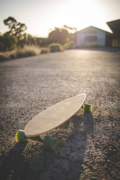 skateboard captured in the golden light of the late afternoon sun.  - Foto, Imagem