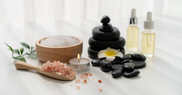 Spa accessory composition set in day spa hotel , beauty wellness center . Spa product are placed in luxury spa resort room , ready for massage therapy from professional service . - Foto, Imagem