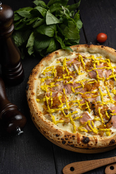Delicious pizza with prosciutto, herbs and cheese. Food delivery - Valokuva, kuva