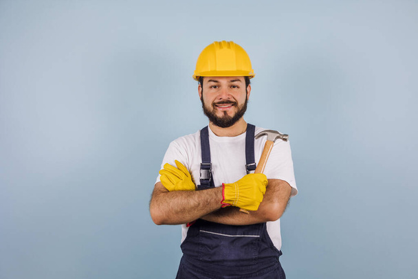 latin bearded young man and Professional worker with hard helmet in Mexico Latin America on colorful background - 写真・画像
