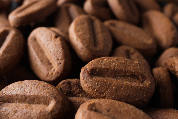 Concept of tasty snack for hot drink - cookies in the shape of coffee seeds - Fotoğraf, Görsel