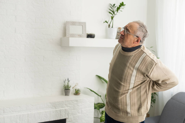 an elderly man has a backache. - Fotoğraf, Görsel