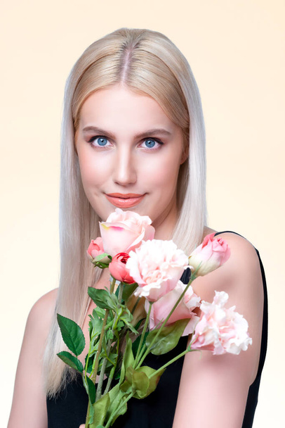 Closeup young personable woman with natural makeup and healthy soft skin holding rose for beauty care advertising in isolated background. Beautiful pretty model girl with flower concept. - Photo, Image