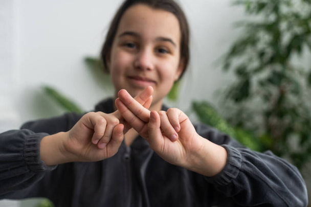 Beautiful smiling deaf girl using sign language - Photo, Image