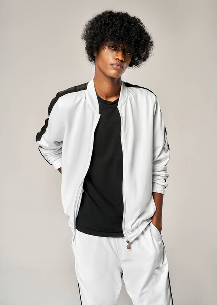 Portrait of fashionable black man in white tracksuit - Fotoğraf, Görsel