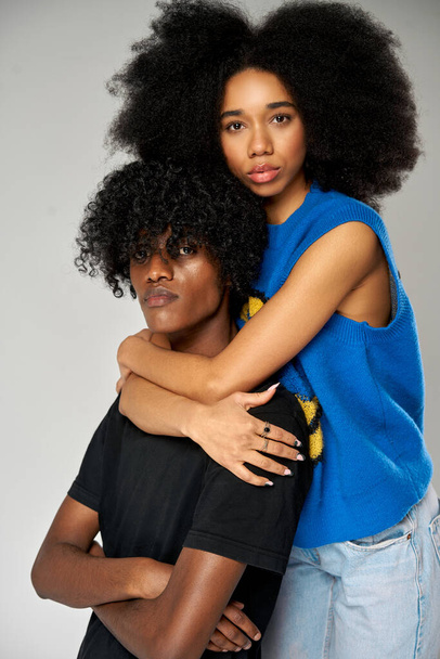 Portrait of african american loving couple over gray background - Foto, afbeelding