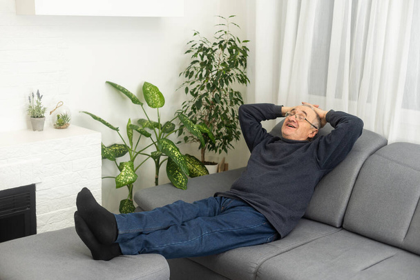 an elderly man is resting at home. - Фото, зображення