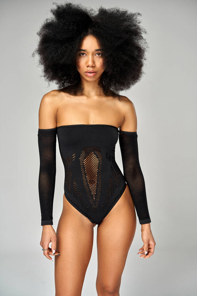Fashion photo of african american girl with an afro hairstyle wear black mesh bodysuit  - Fotó, kép