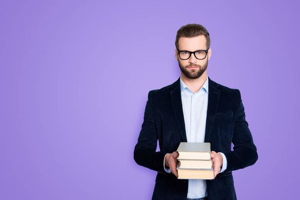Portrait with copy space, empty place of stylish trendy teacher in shirt, jacket with stubble having three books in hands, looking at camera isolated on grey background. - Fotoğraf, Görsel