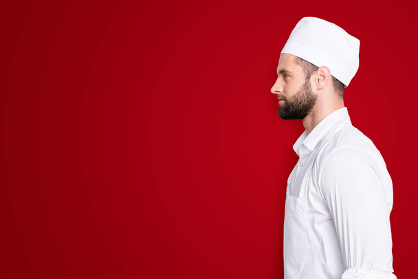 Profile side view portrait with copyspace, empty place for advertisement of attractive handsome butcher standing over grey background. - Foto, Imagem