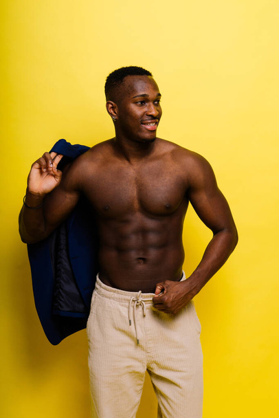 African black man model in a blue suit topless, studio background - Photo, Image
