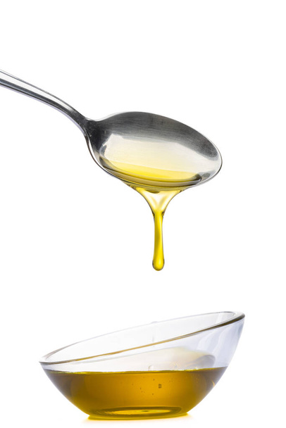 Organic olive oil pouring from the spoon - Φωτογραφία, εικόνα