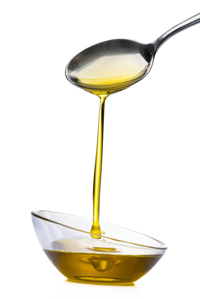 Organic olive oil pouring from the spoon - Photo, image