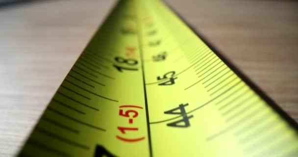 Cinta métrica de centímetro amarillo para medir la distancia durante el primer plano de la construcción Película 4k. Concepto herramientas de construcción - Imágenes, Vídeo