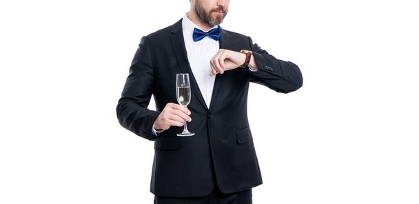 man in tuxedo cheers and celebrate check time in studio. man in tuxedo to cheers and celebrate. tuxedo man hold champagne. tuxedo man cheers and celebrate isolated on white. cheers and celebrate. - Foto, Imagem