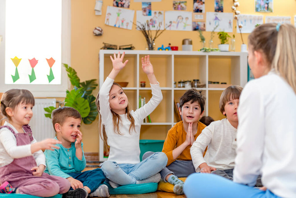 Active preschool Children Interacting with their Teacher. Teacher-child relationships  Early Learning. Healthy Learning Environment - Photo, Image