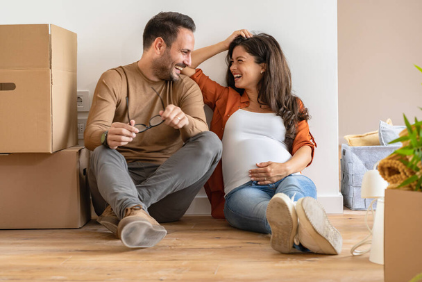 νεαρό ζευγάρι, μελλοντικοί γονείς σε νέο διαμέρισμα - Φωτογραφία, εικόνα
