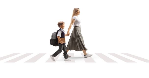 Mother taking son to school and crossing street at a pedestrian zebra sign isolated on white background - Фото, изображение