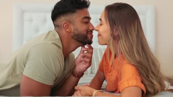 Couple, nose touch and kiss with love and commitment, happiness with trust, support with care and relax together. Partnership, romance and bond, tender moment at home and interracial relationship. - Footage, Video