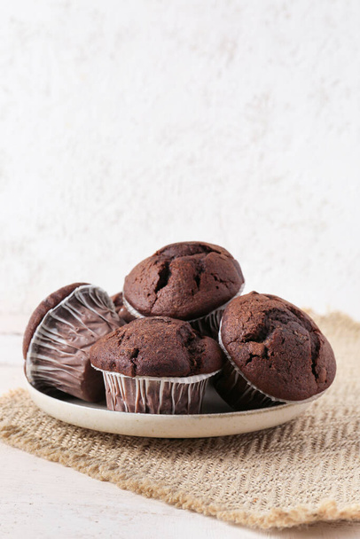 Plate with tasty chocolate cupcakes on table - Photo, Image